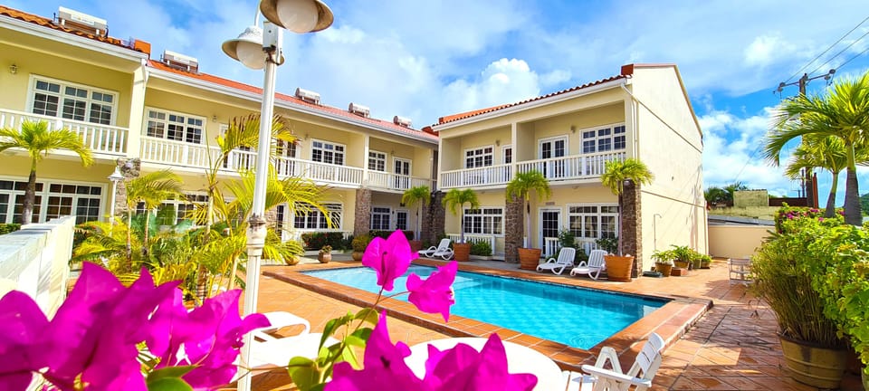 An exterior view of the condominium complex overlooking the pool and pool deck.