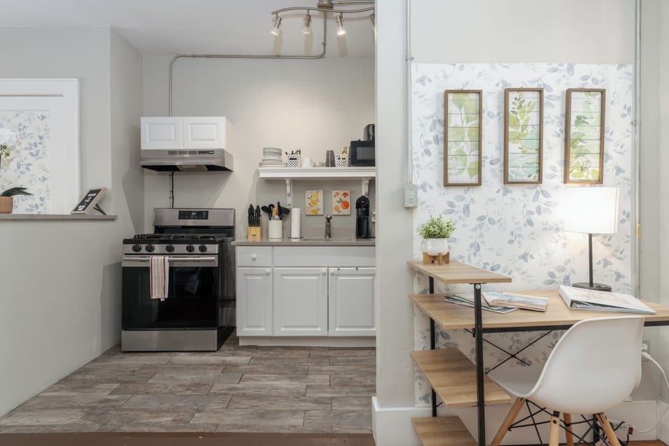 Where culinary creativity meets productivity: a spacious kitchen-office combo designed for seamless cooking and working.