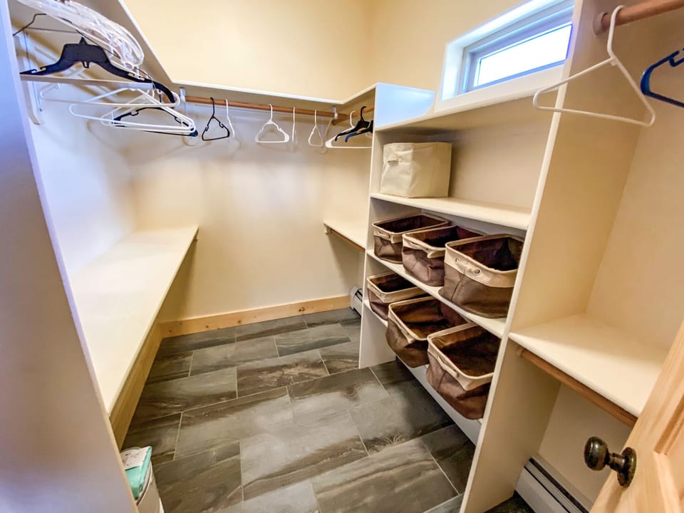 As you enter the En Suite Bathroom you'll find a spacious closet with plenty of hanging space and storage bins