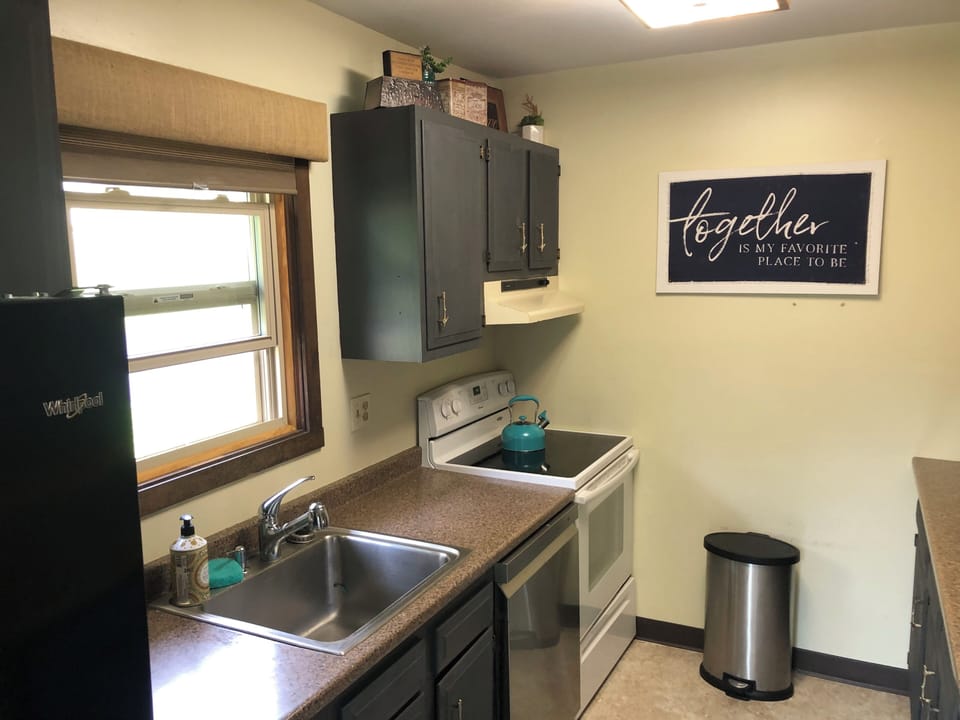 Kitchen includes plenty of cooking utensils