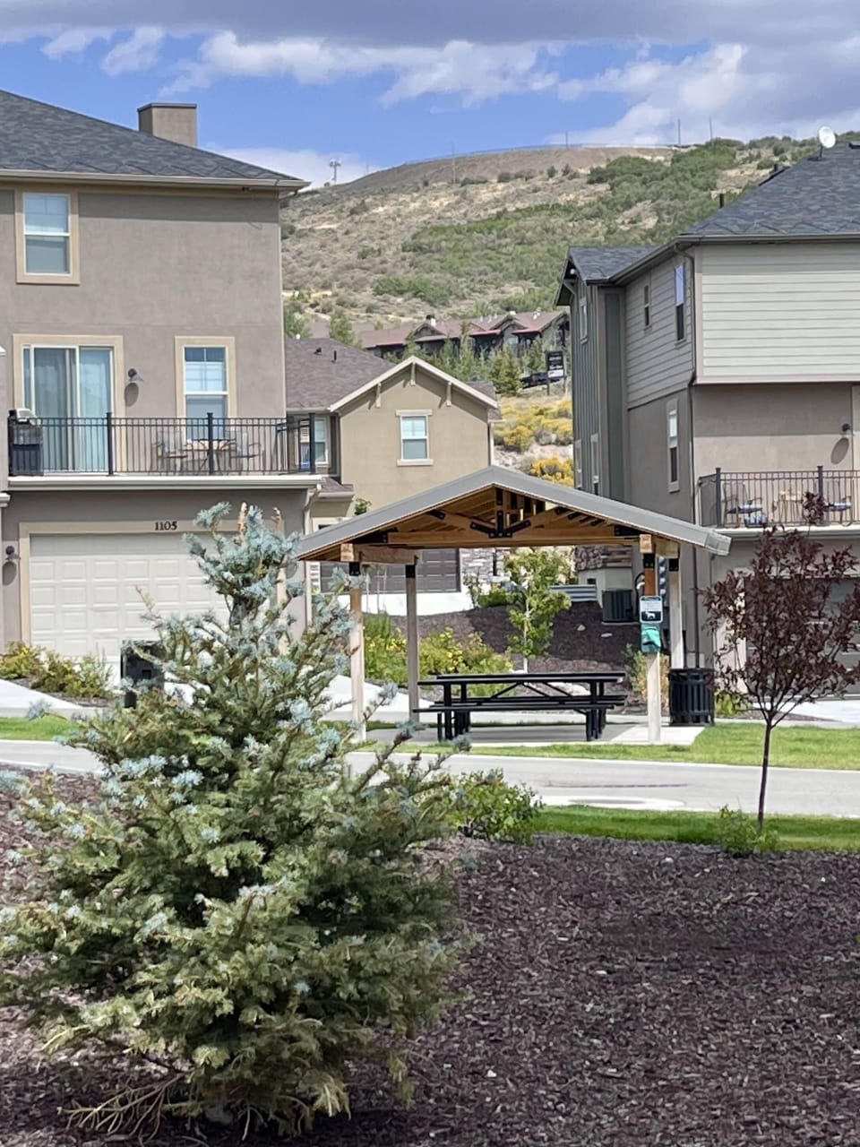 neighborhood picnic pavilion, with grassy area and small playground
