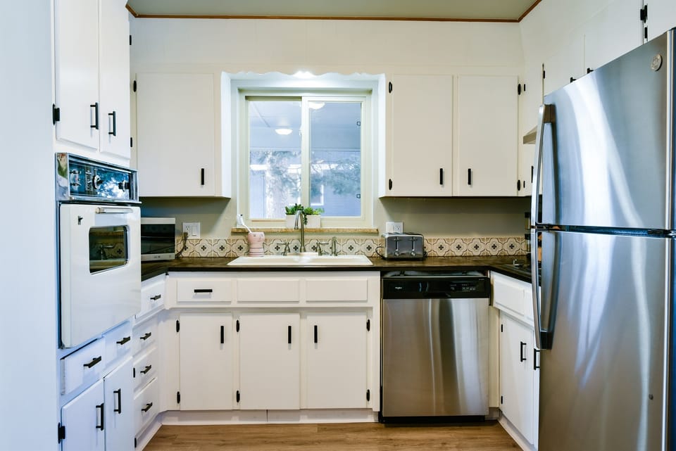 Updated modern vintage 1960s kitchen fully stocked with essential cooking items