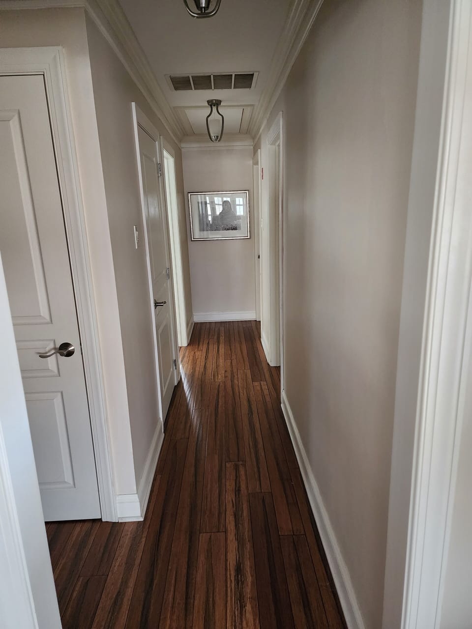 Hallway to bedrooms, bathroom, linen and coat closets. 