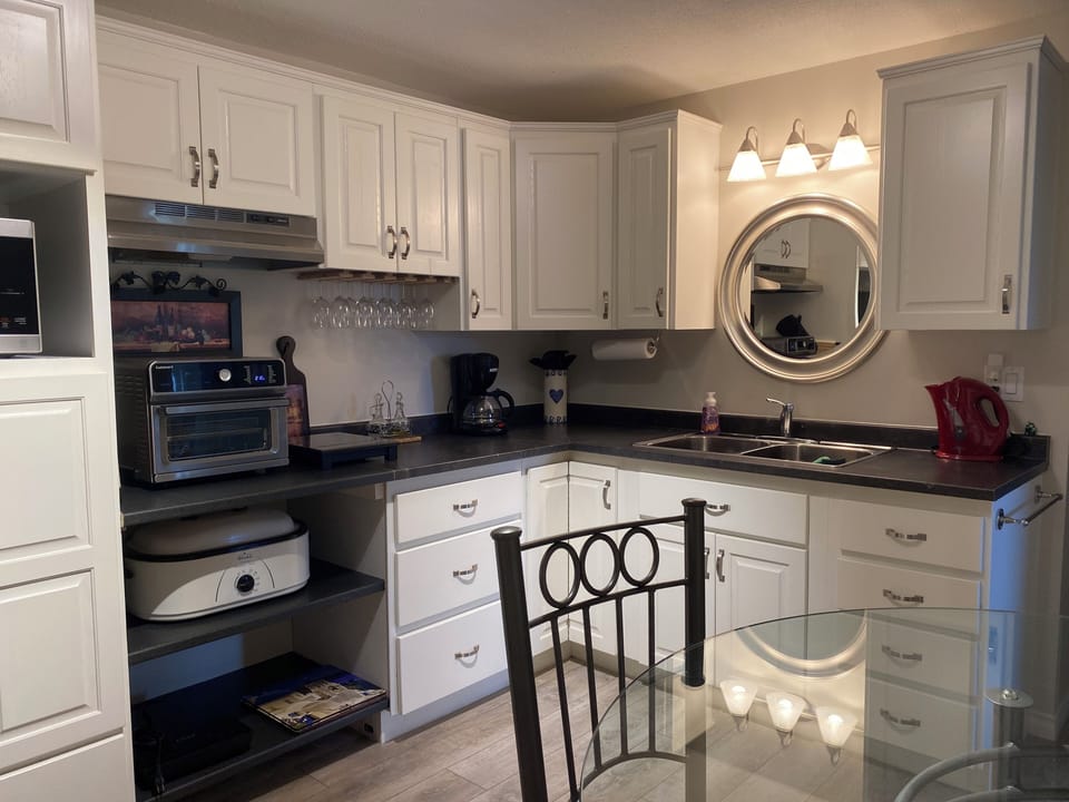 Full size kitchen with air fryer, oven, induction stove tops. 