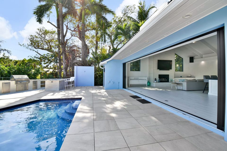 Huge sliding doors allow for seamless transition between indoor and outdoor living