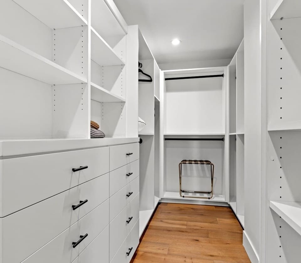 spacious modern walk-in closet with ample shelving and drawers