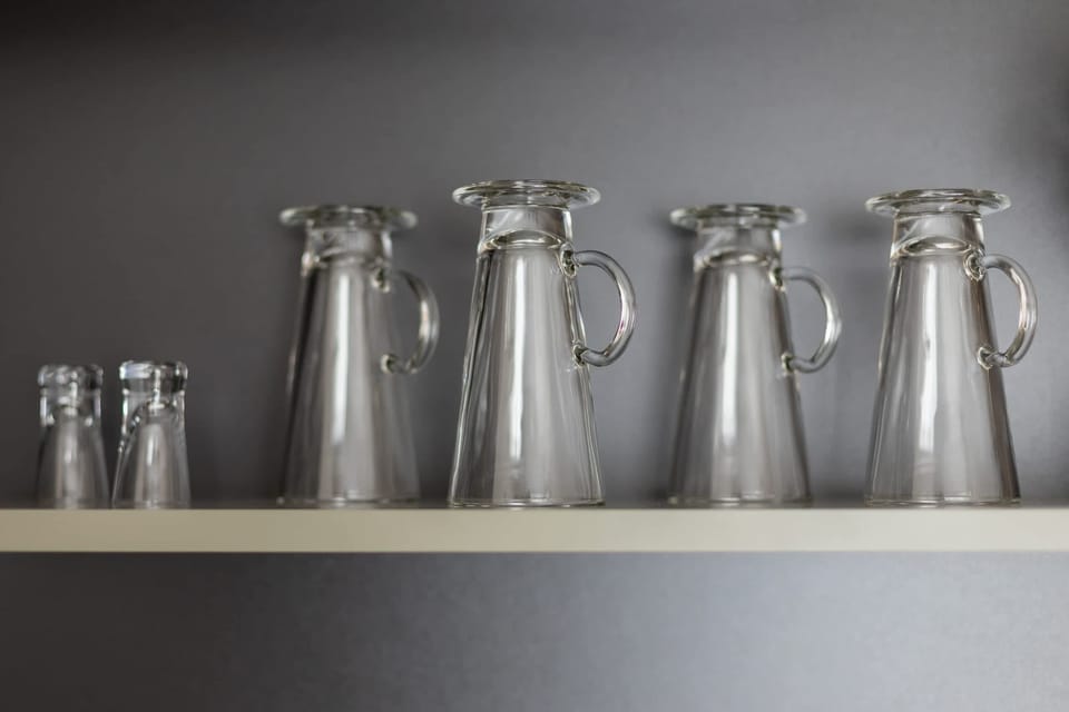 A close-up of glasses neatly arranged on a shelf, emphasizing the apartment's attention to detail.