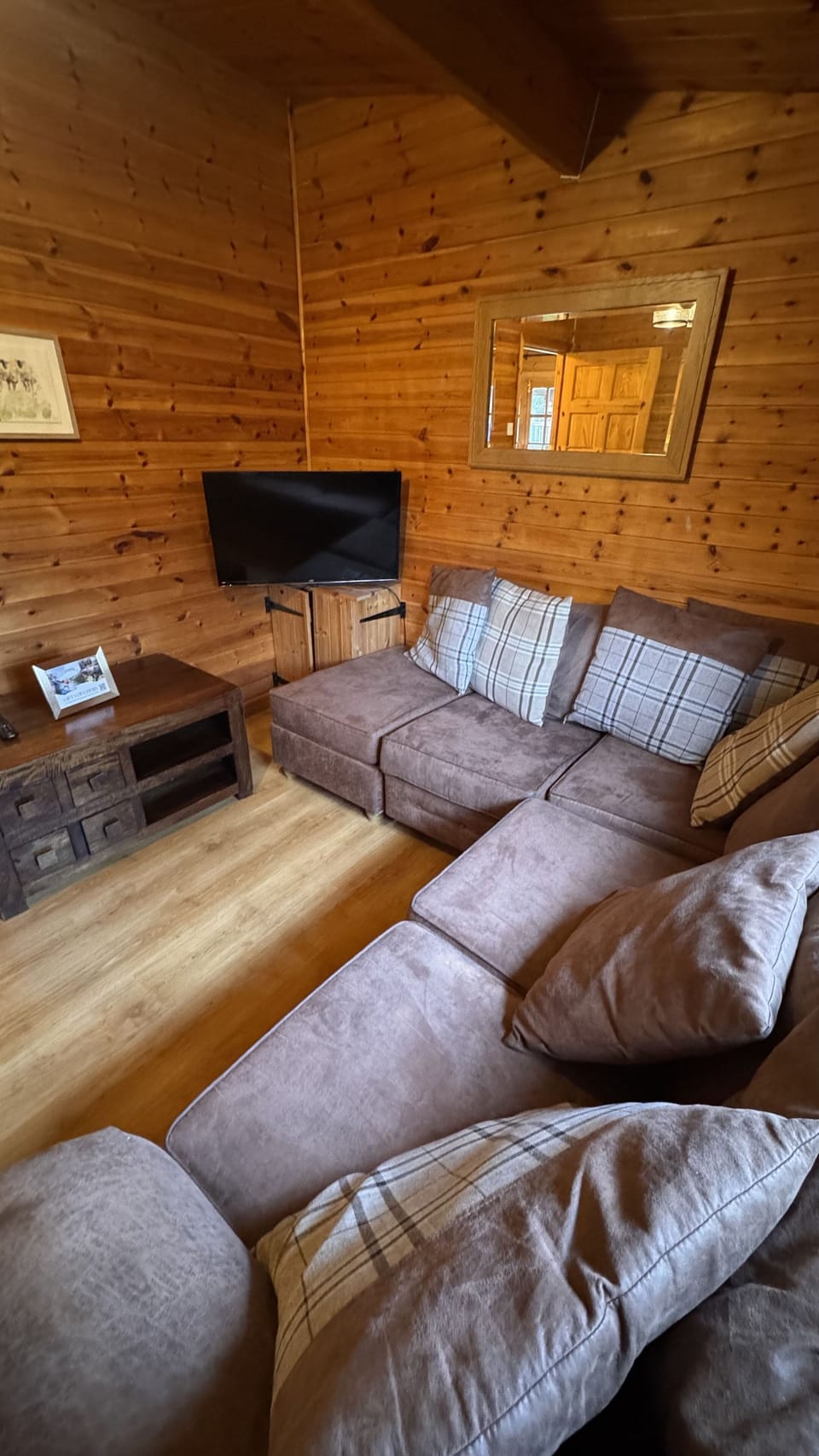 Lounge with corner sofa, coffee table and flat screen tv