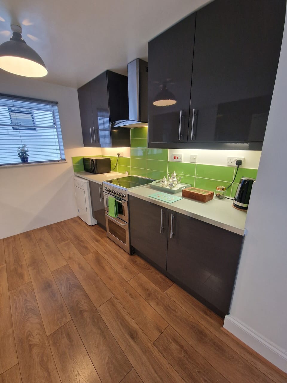 Modern kitchen with oven, hob, dryer, microwave and washing machine