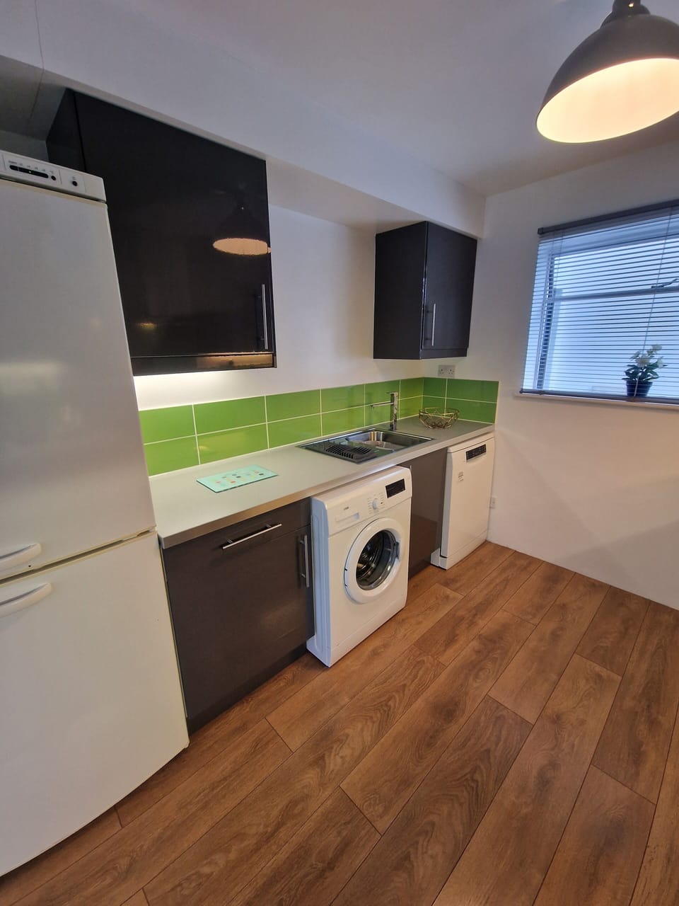 Modern kitchen with fridge freezer, dishwasher and washing machine