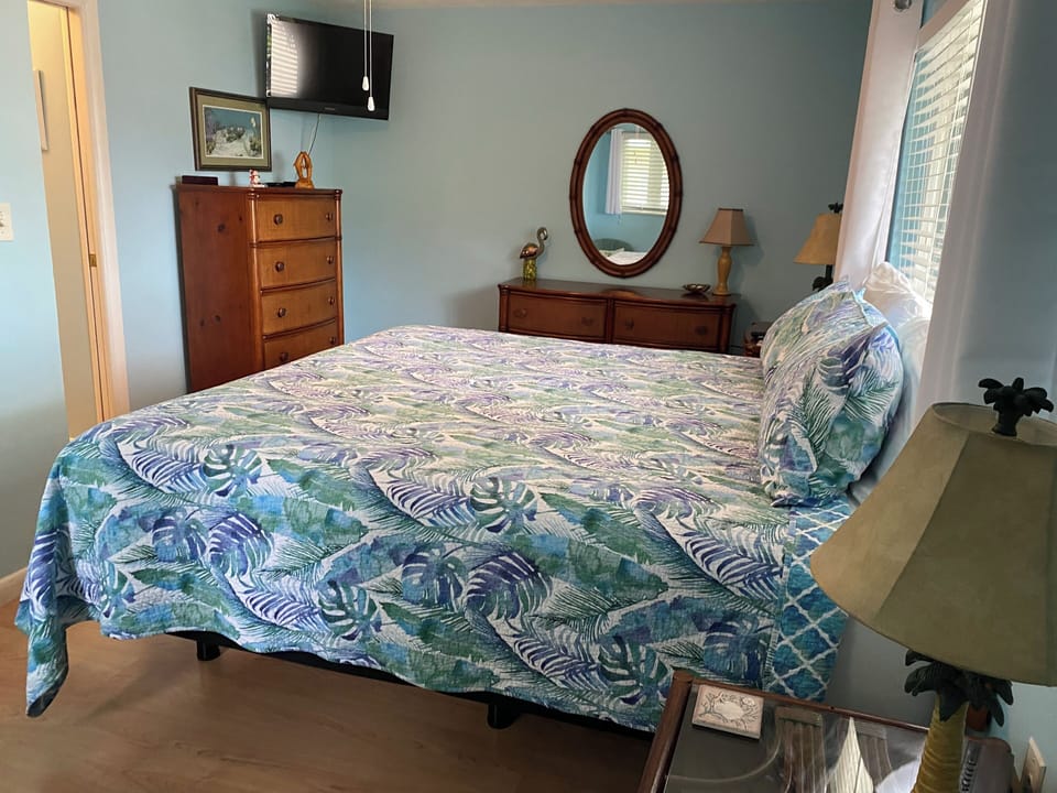 The king bedroom has ample storage and a wall mounted tv for easy viewing.
