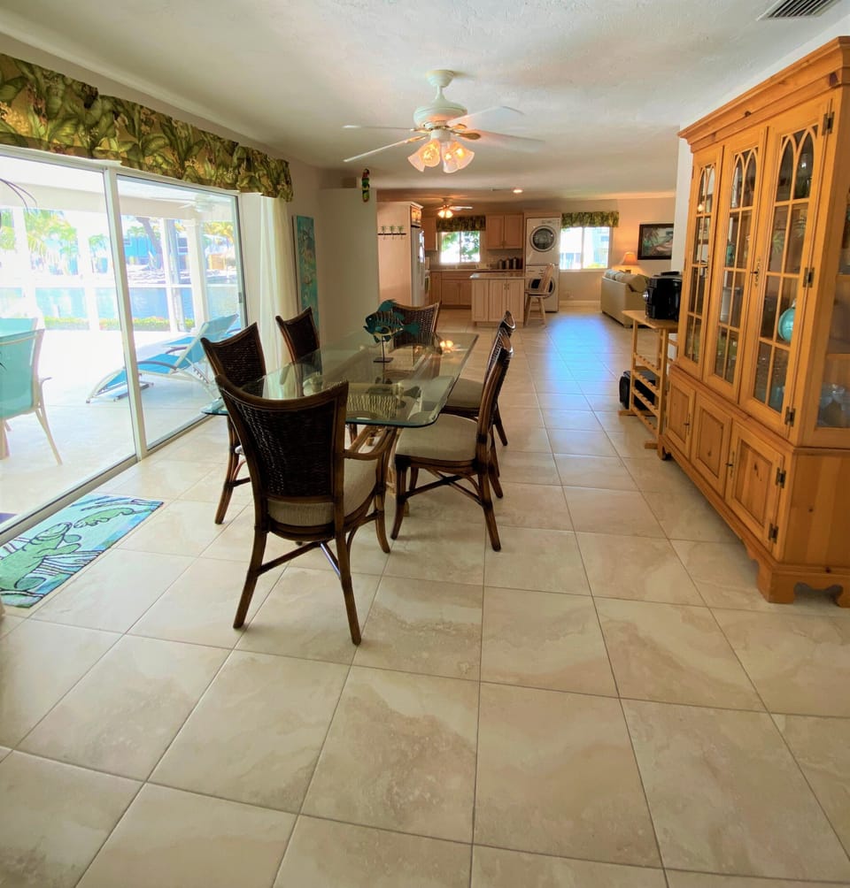 The dining room is complete with a hutch full of extra glass/pool ware. 