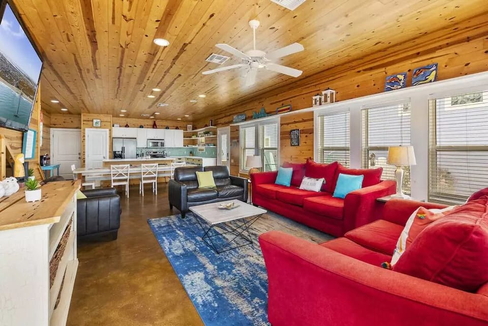 The living room is spacious with room for all of your family and friends