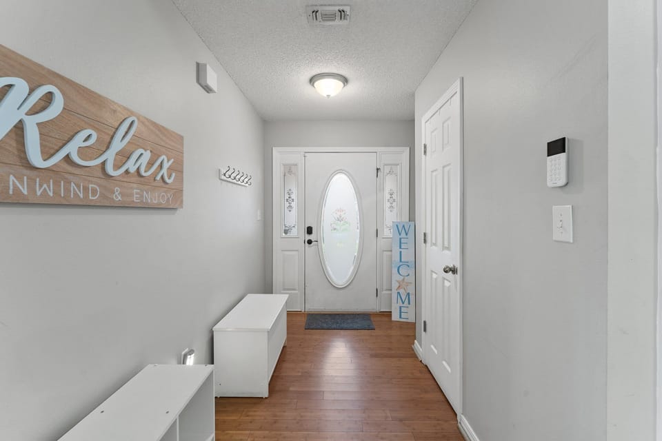 Welcoming entryway with coastal accents and functional storage—setting the tone for a relaxing beach getaway from the moment you arrive.