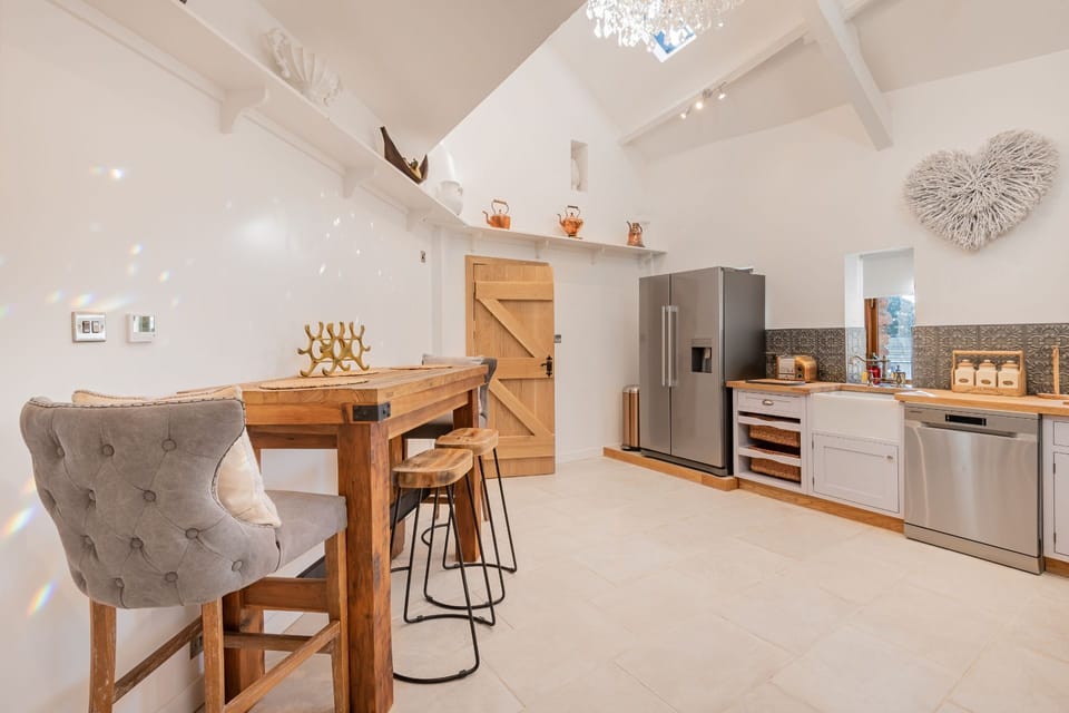 The kitchen bar with cushioned stools at Rose Walls, Lake District