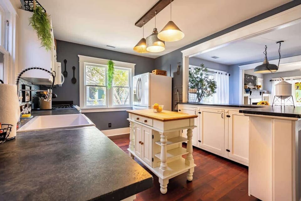 A well-stocked and spacious kitchen equipped with complete dinnerware, cookware, and modern appliances, perfect for preparing and enjoying hot, home-cooked meals during your stay.