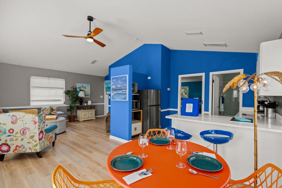 Siesta Key Beach open-plan suite with bold walls, full kitchen, and vibrant dining setup