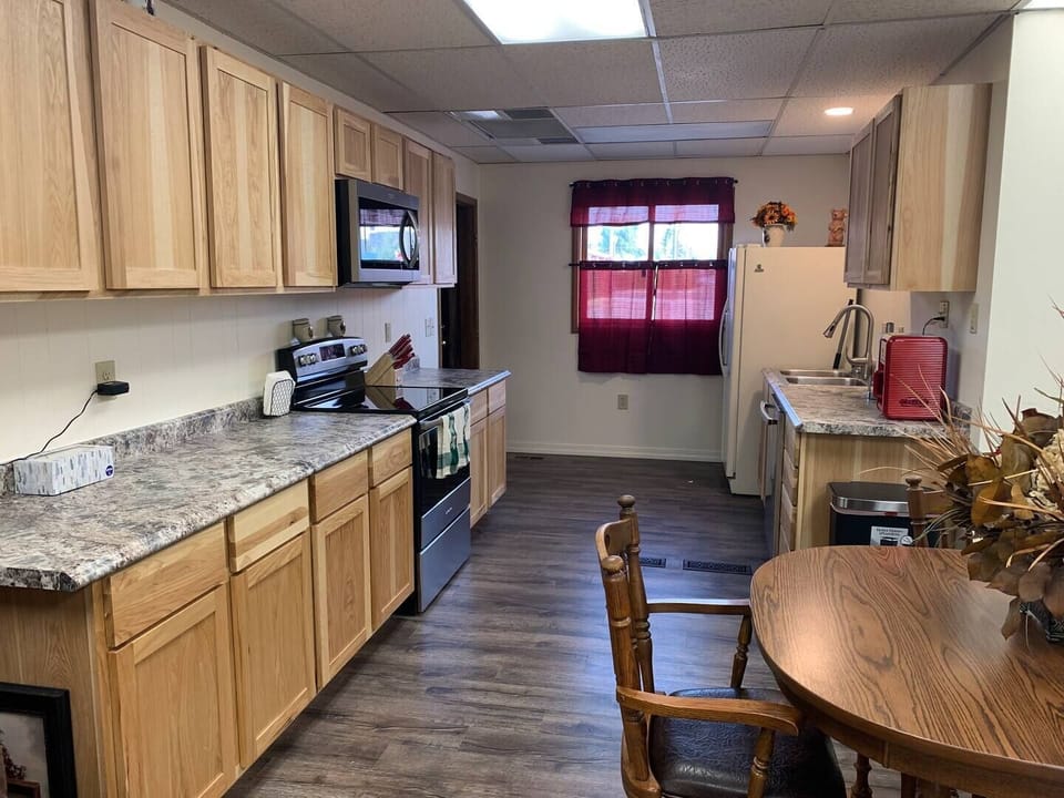 Nice open kitchen, fully stocked with pots, pans, dishes, silverware, cooking utensils, microwave, stove, coffee pot, wine glasses and more.