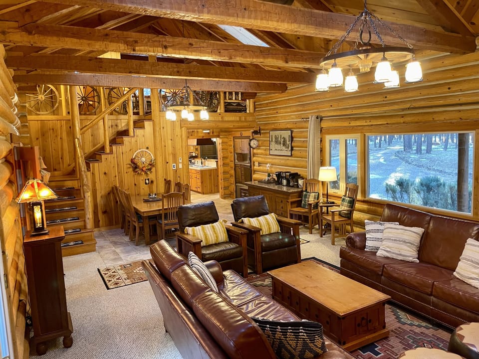 Hand hued logs and beams make up the walls and vaulted ceiling in the great room