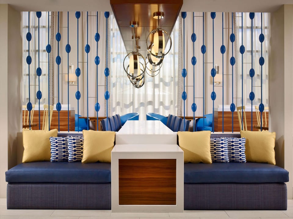 Sink into plush seating under glowing statement pendants.