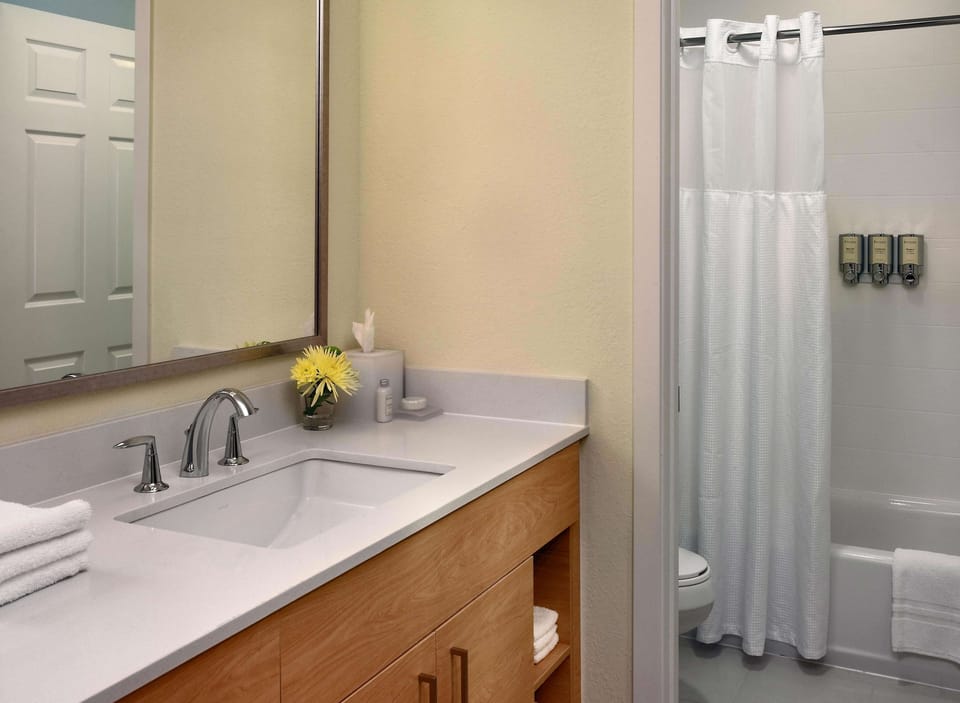 Refresh easily in a spotless bath with shower and ample counter.