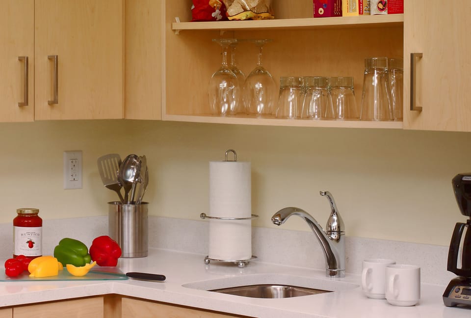 Prep easy snacks with a bright counter, sink, and coffee maker.