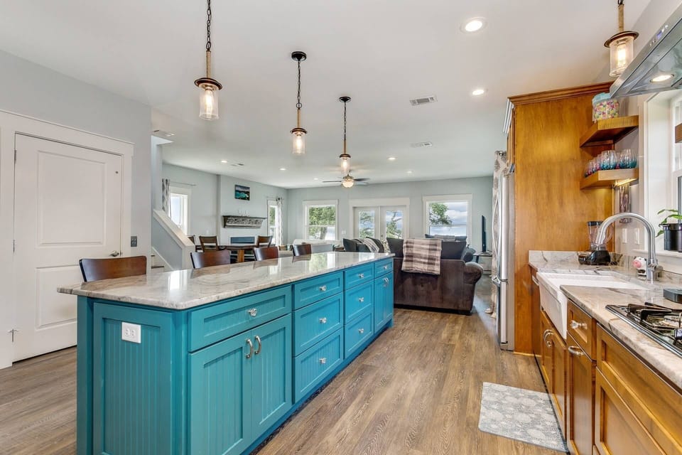Granite countertops and a huge island with brand new stainless appliances and a gas stove