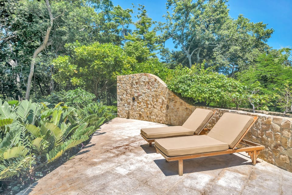 Comfortable lounge chairs, surrounded by the beauty of nature and captivating ocean views