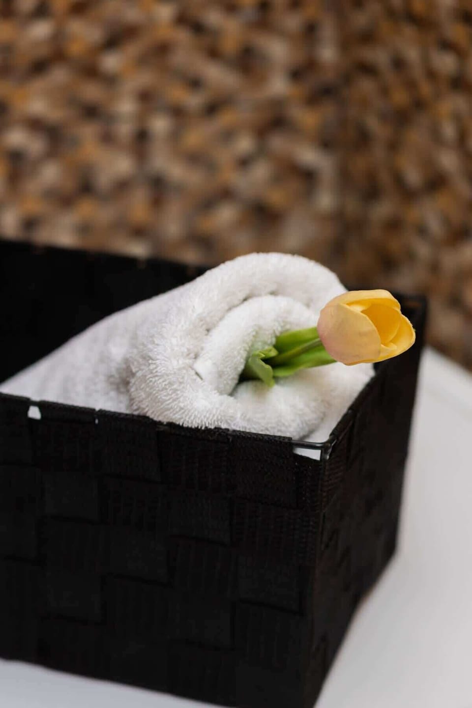A close-up of a basket with towels and toiletries, emphasizing comfort and hospitality.
