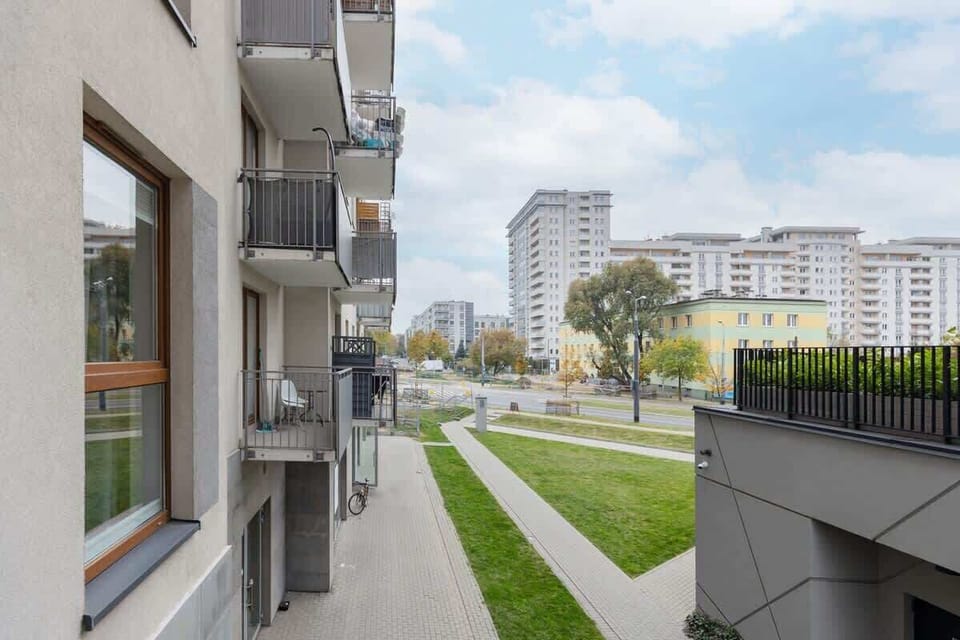 A view from the balcony, showing modern architecture and the surrounding neighborhood.
