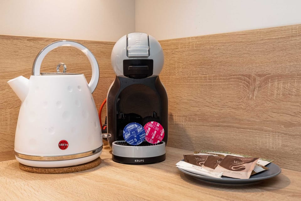 A countertop setup including a kettle and coffee machine, offering a welcoming touch.