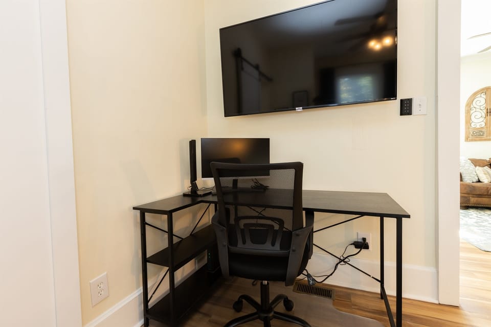 Bedroom #1 with King Bed, En-Suite Bathroom, Adjustable 55 inch ROKU TV, Work Station with desk, lamp and monitor, Sound Machine & Blackout Curtains
