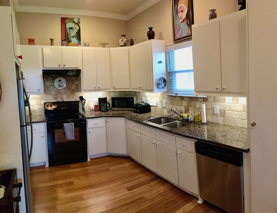 Double sink w/ garbage disposal.  granite countertops.  Tile backsplash.