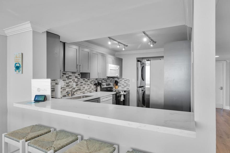 Breakfast bar. Full size stackable washer/dryer.