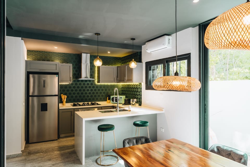 Full kitchen w/ Nespresso machine, coffee, tea, spices, blender, oven microwave, and gas range