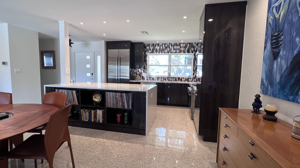 An open floor plan. Opposite the kitchen are 2 of the 3 bedrooms and full bath.