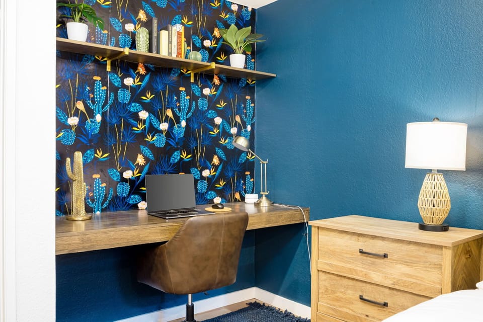 The office area in the primary bedroom offers a large desk and additional router