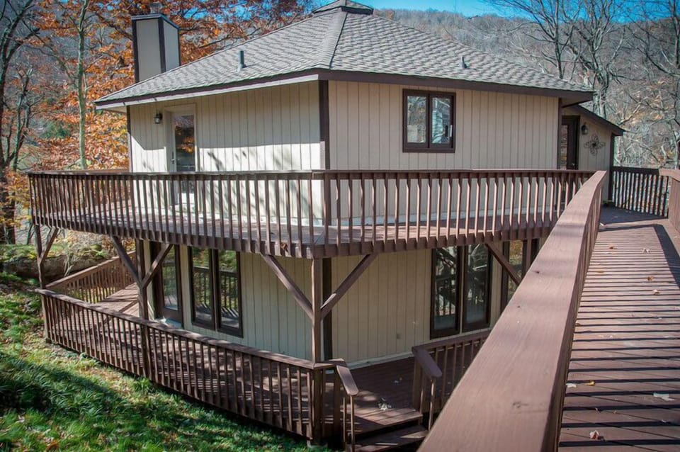 Inviting mountain cabin with a spacious wraparound deck and wooded views.