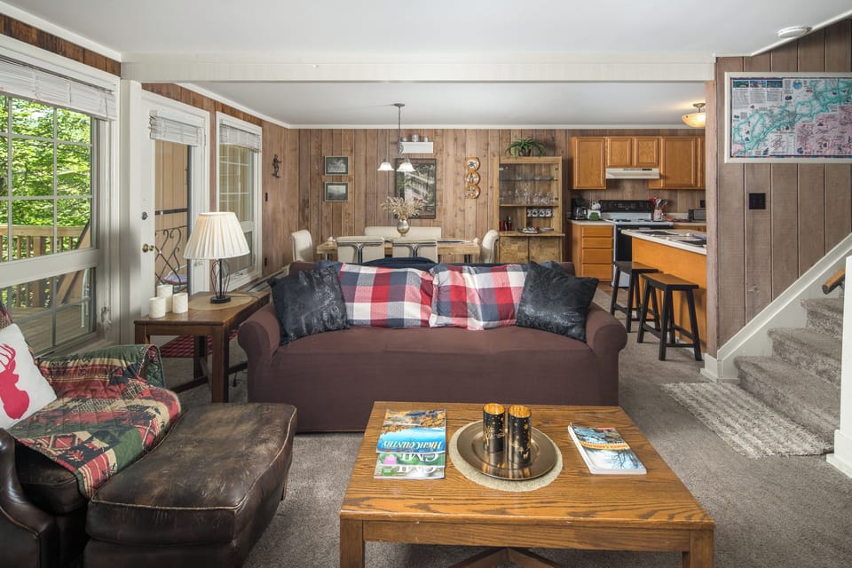 Warm living area with deck access and rustic finishes.