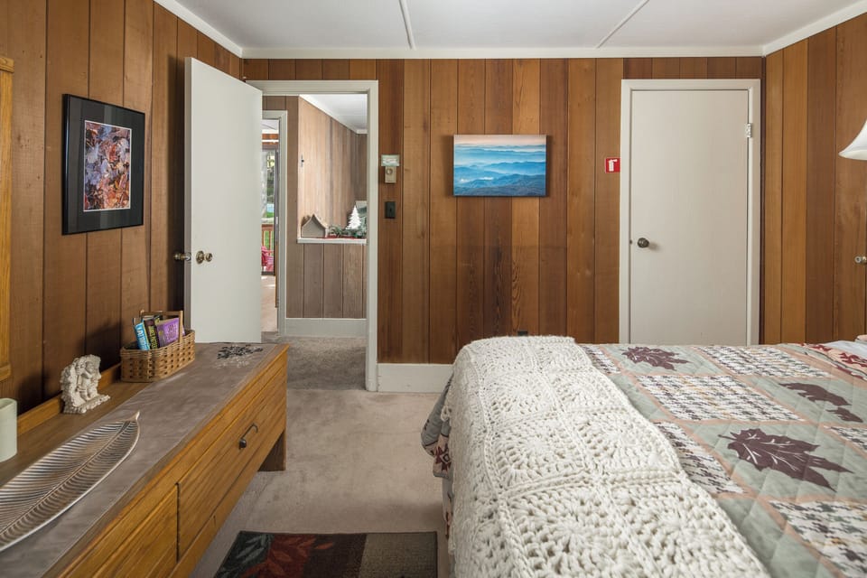 Cozy bedroom with warm lighting and rustic wood accents.