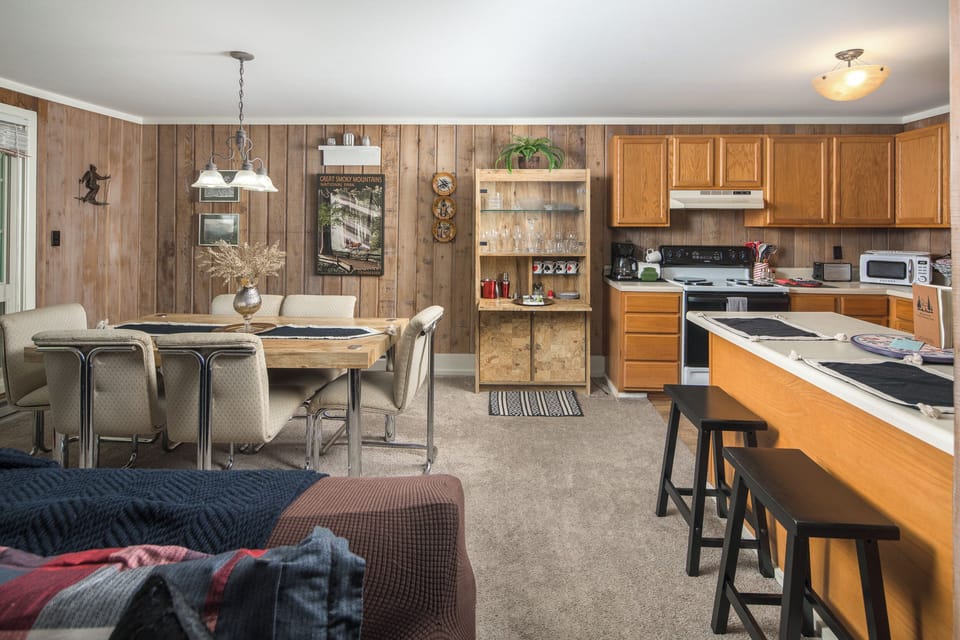 Full kitchen with adjacent dining area and rustic charm.
