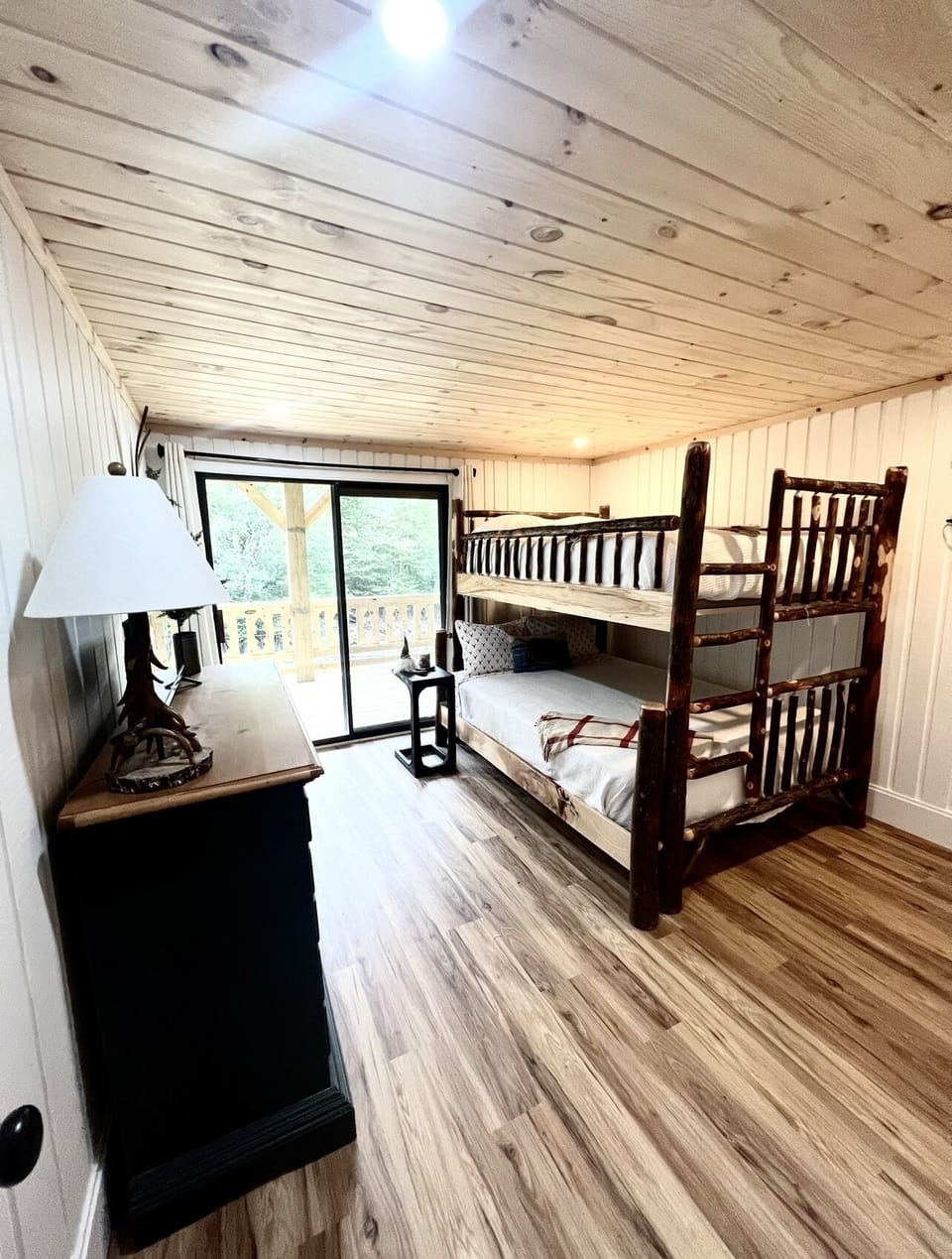 Rustic bunk room with balcony access—perfect for kids!