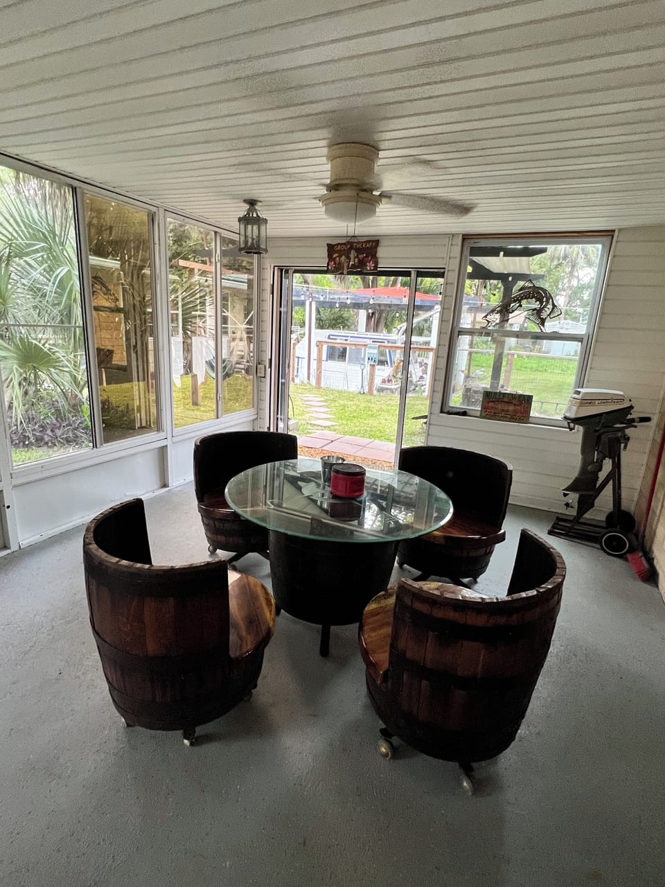Whiskey barrel, chairs and table on the back patio