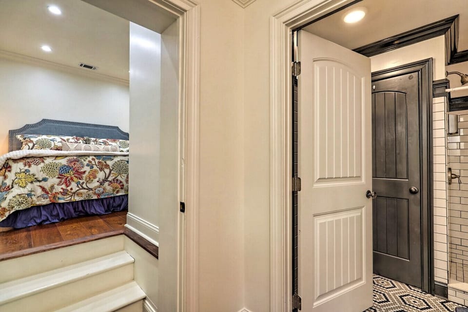 The primary bedroom is just steps away from the main bathroom entrance in the hallway