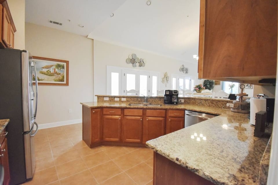 The kitchen is fully equipped with blenders, air fryer, ice cream maker, bakeware, and pressure cooker. From the entryway to the walk-in pantry, you have access to the sun deck.