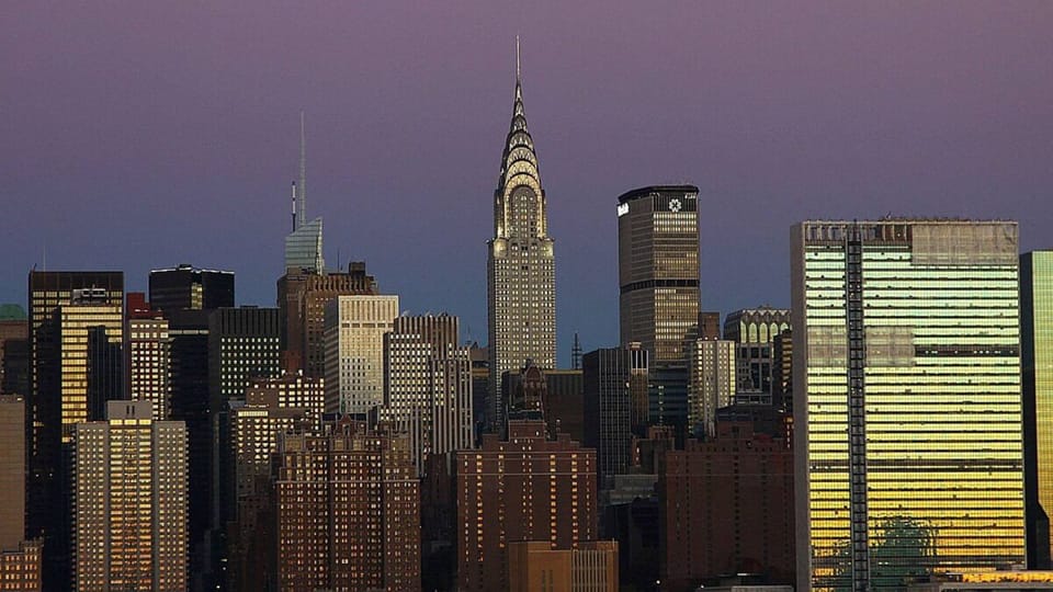 Watch the city glow as evening lights sparkle outside.
