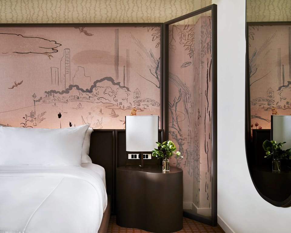 Sink into crisp linens beside artful screens and soft lighting.
