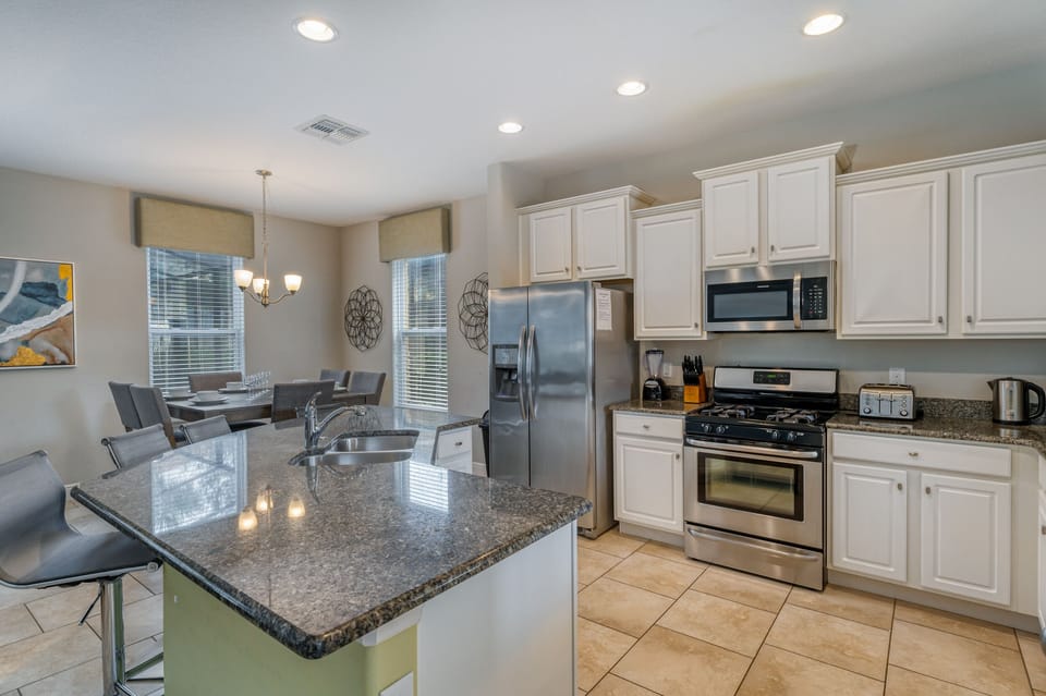 Spacious kitchen showing breakfast bar and nook area