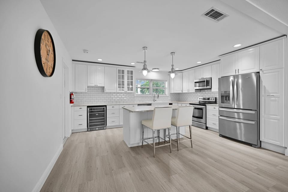 Modern kitchen with new appliances and breakfast bar that seats 2