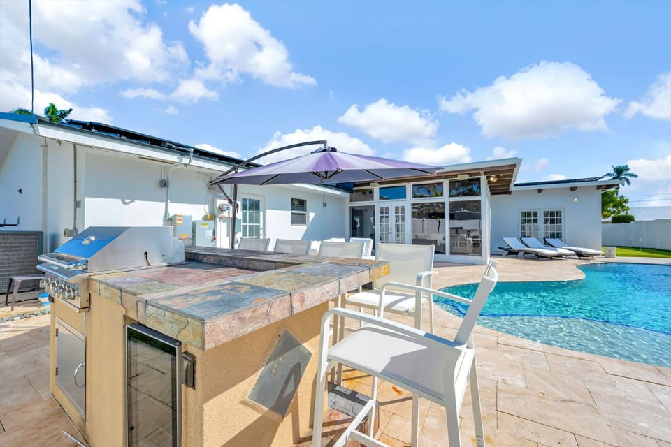 Heated Pool & Hot Tub with outdoor seating and dining area with BBQ